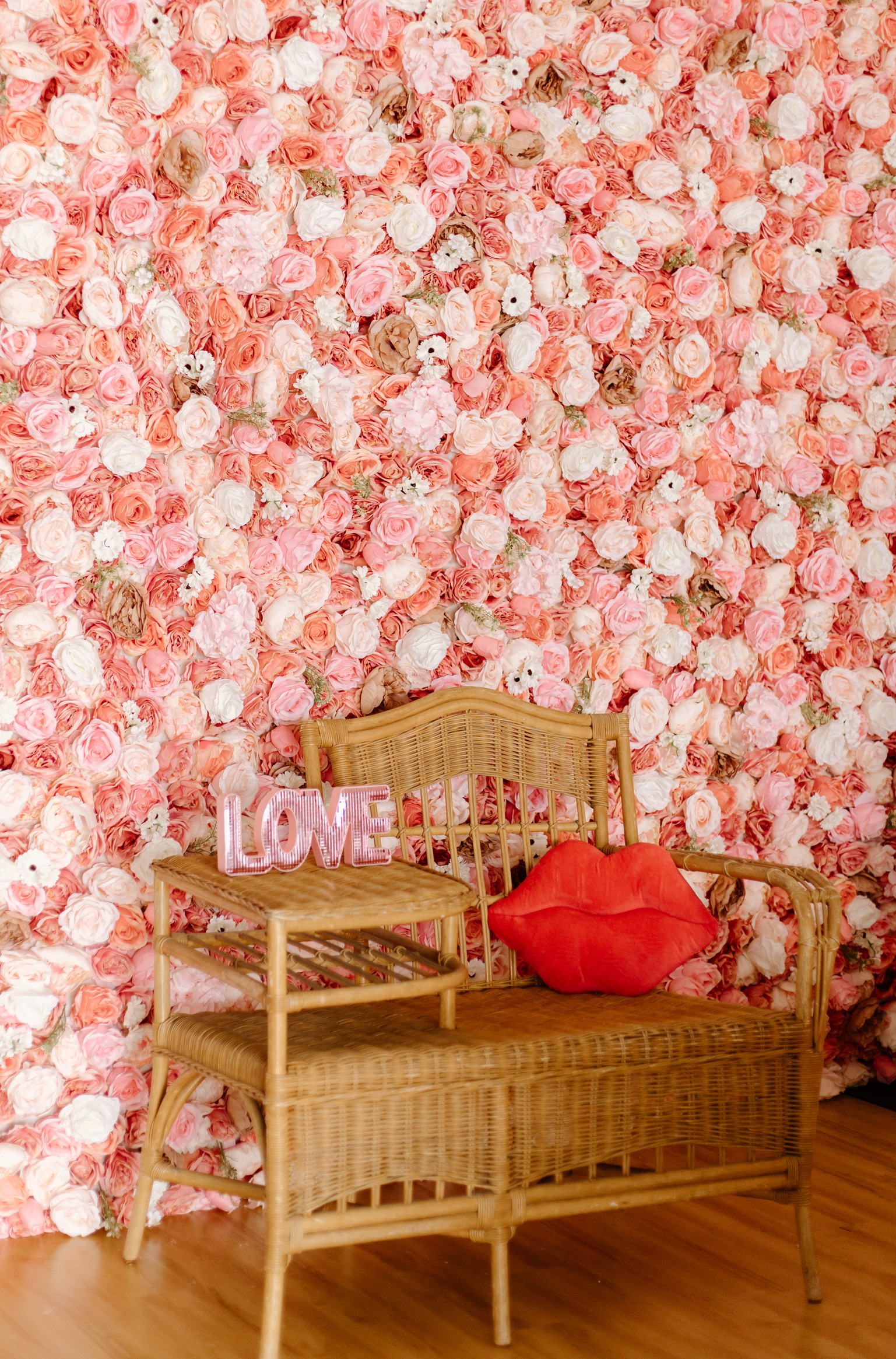 Pink Rose Flower Wall with Wicker Gossip Bench